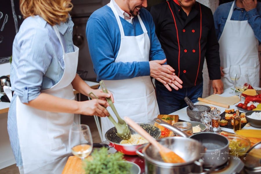 Chef teaching couple in a cooking class