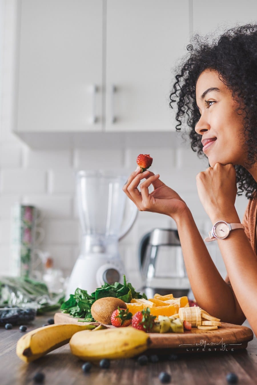 Shot of a young woman making a healthy snack with fruit at home