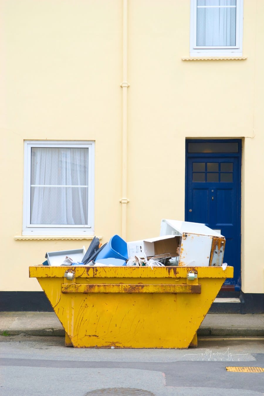 Yellow Dumpster Skip Bin Full of Garbage on the Street