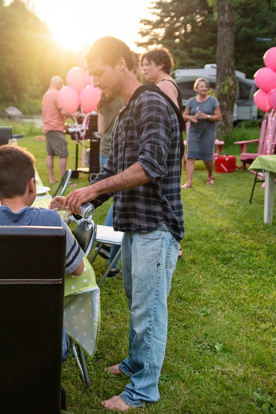 Big family barbecue gathering at sunset, summer outdoors. family reunion