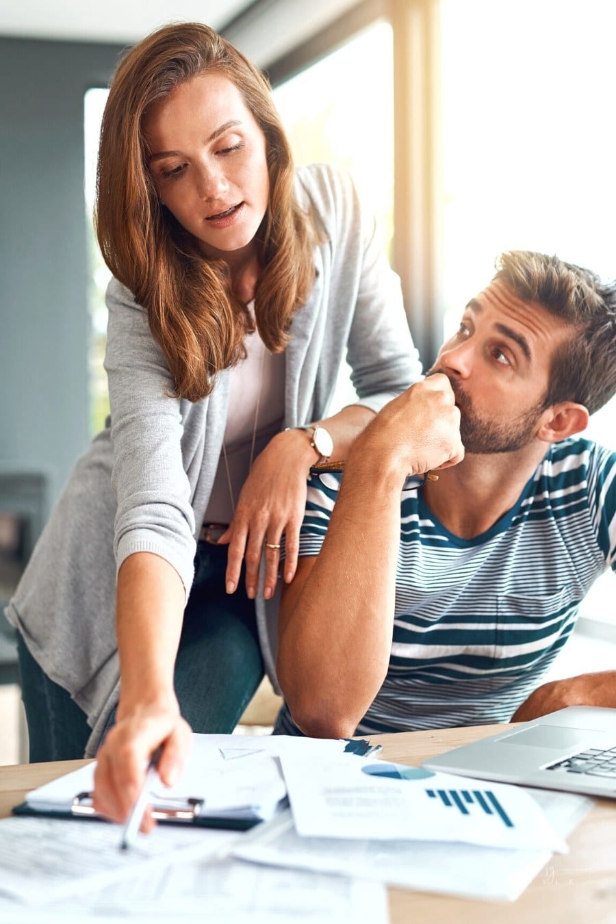 couple working on income taxes at laptop