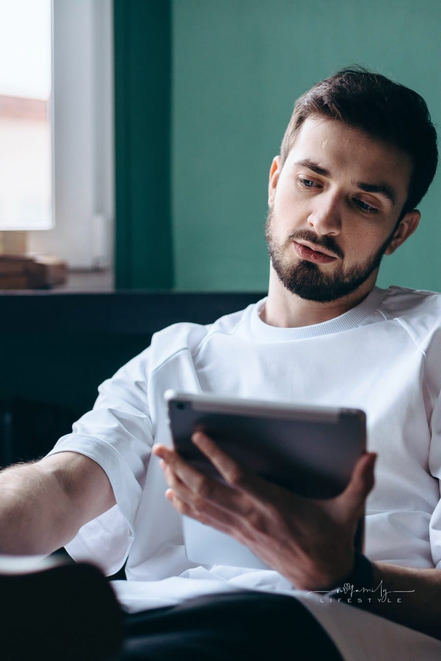 Man in White Shirt Holding an Ipad