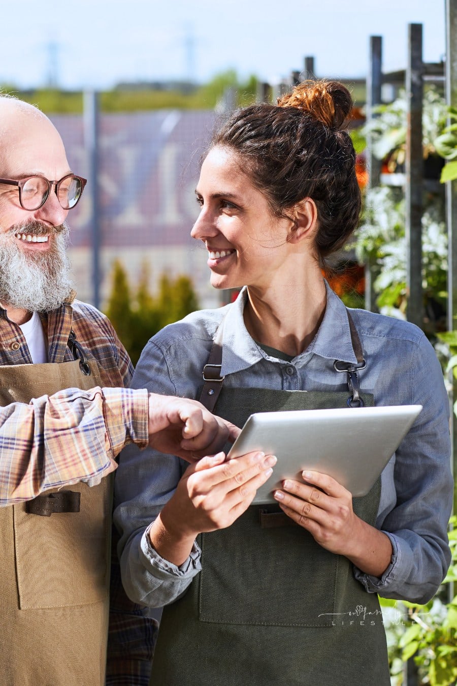 Smiling Workers at Plantation with Digital Tablet