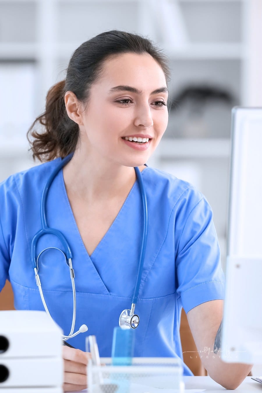 female nurse at workplace computer