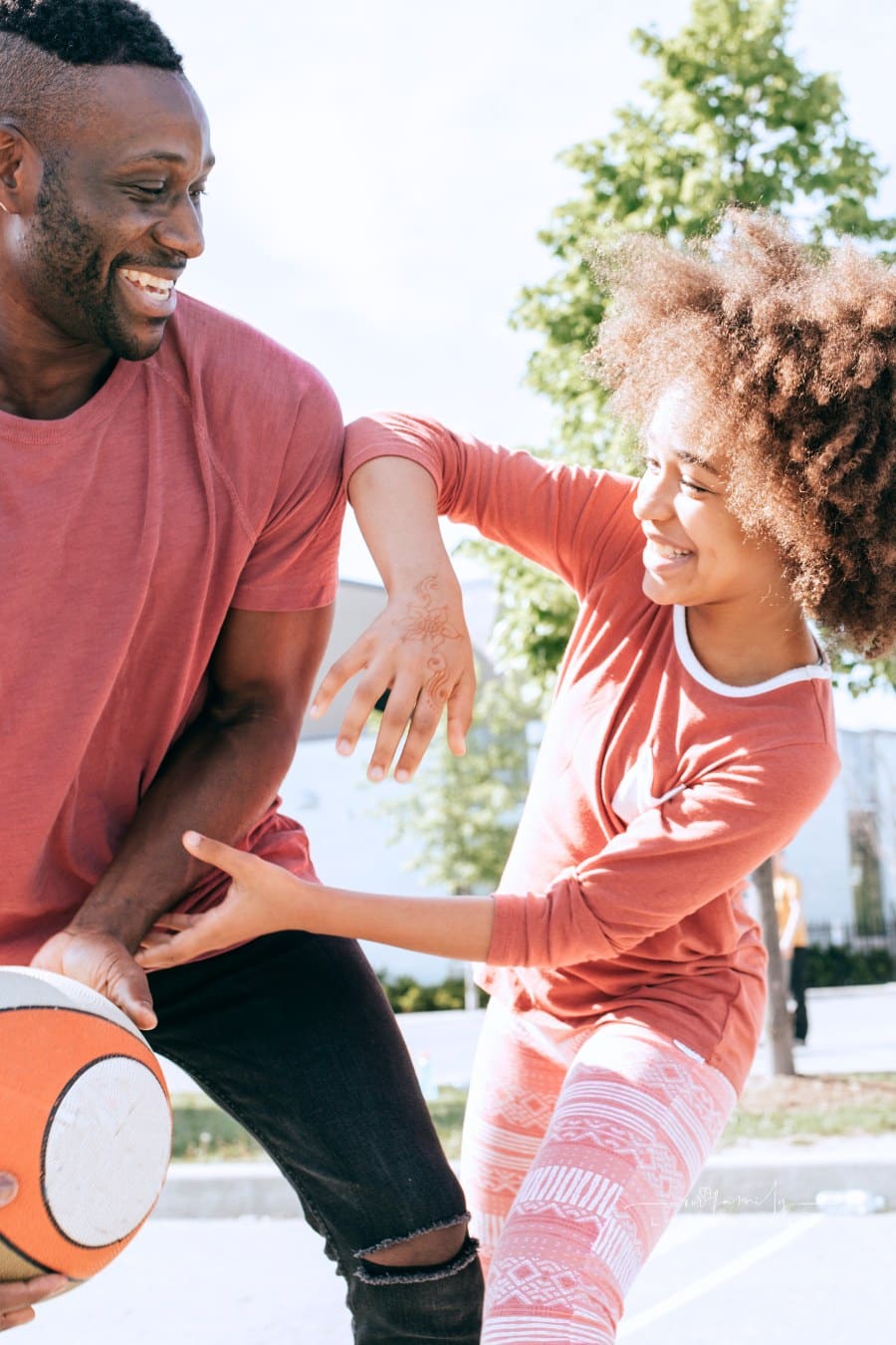Dad playing basketball with daughter
