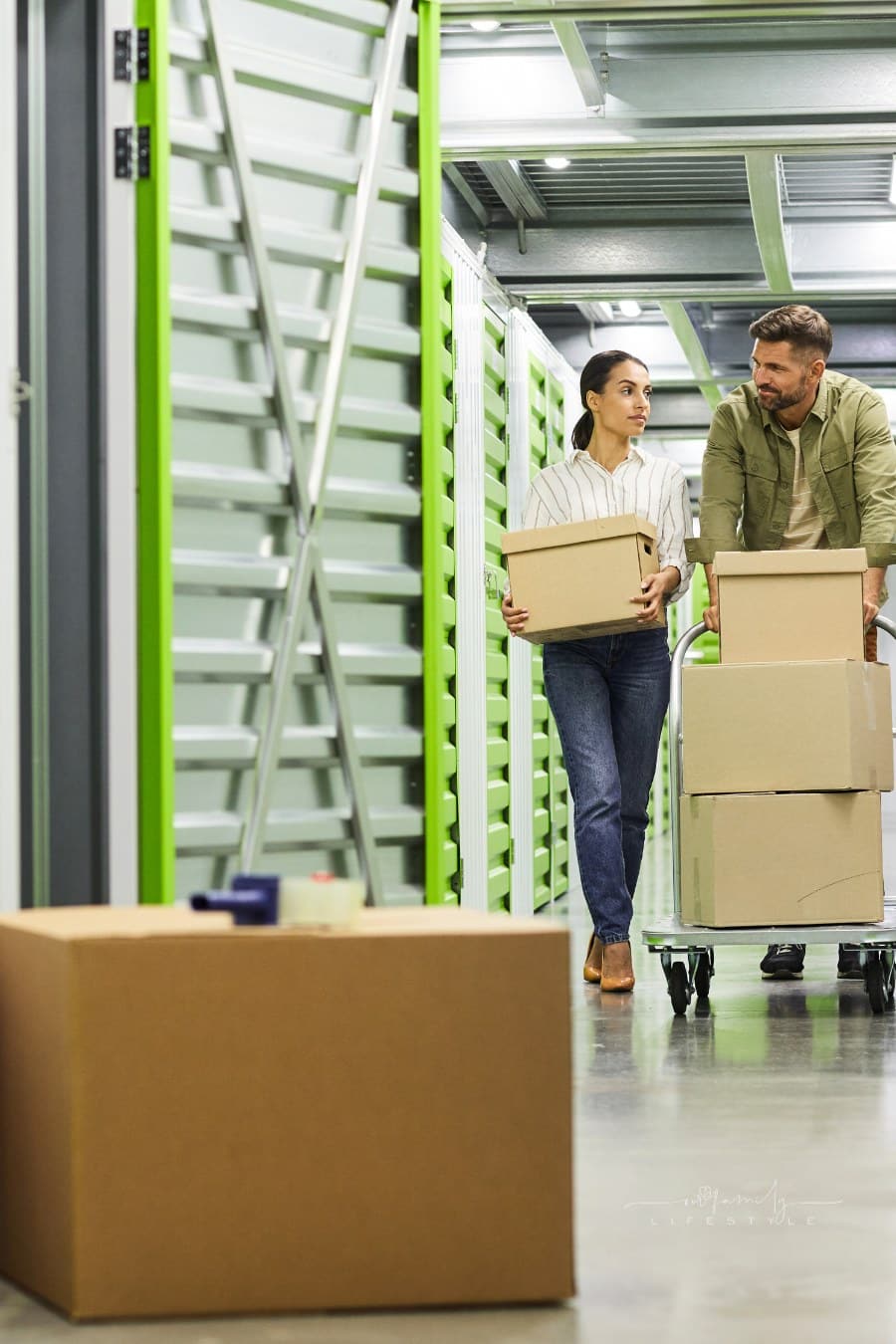 Couple Moving Boxes in Storage Unit