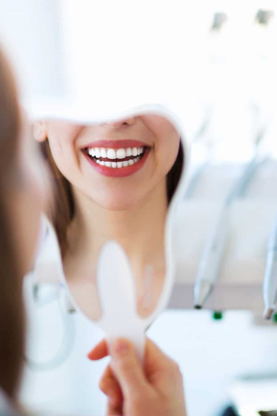 Woman having teeth examined at dentist