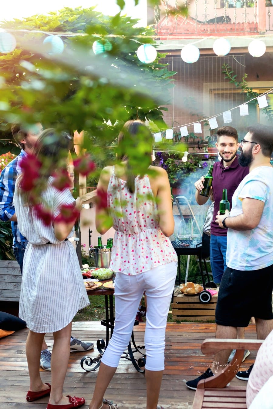 Group of pretty young people have barbecue party in a backyard