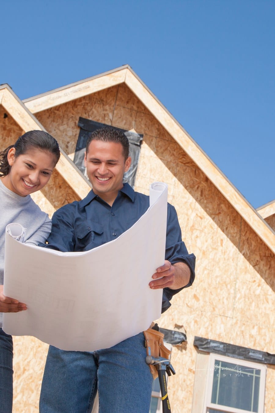 Couple looking at Building plans for new Home