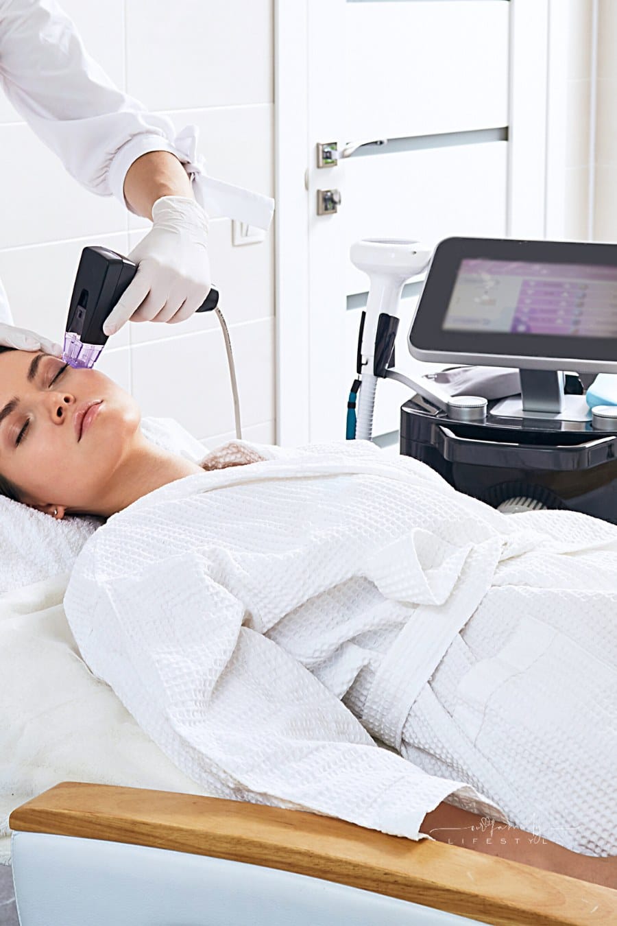 Brunette woman receiving Morpheus8 radiofrequency lifting procedure for her face skin rejuvenation at cosmetology center