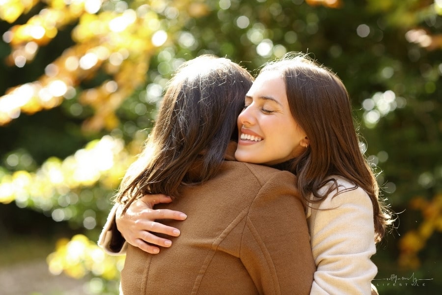 two women hugging outdoors