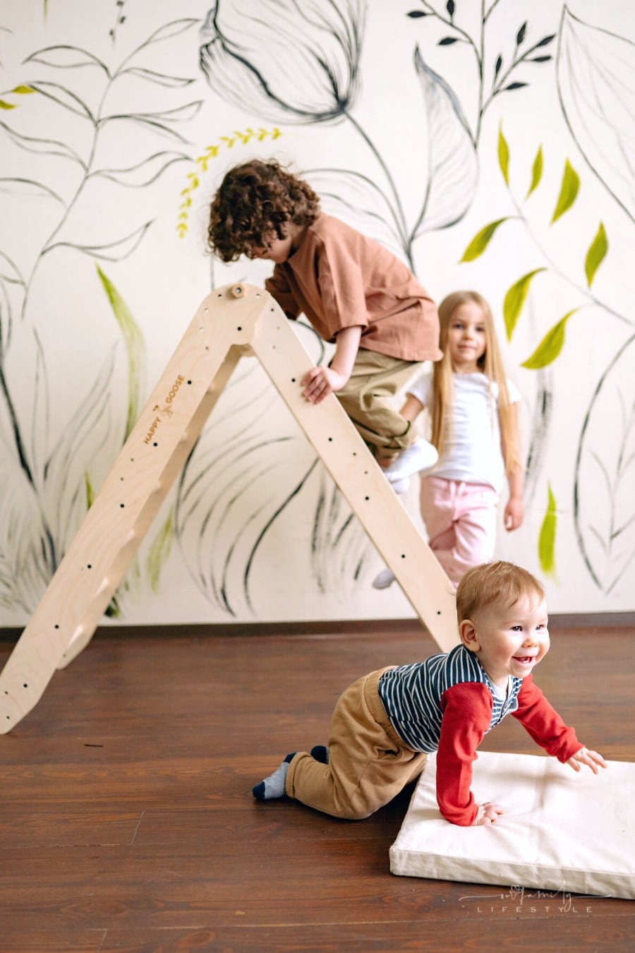toddlers playing together on wooden pickler toy