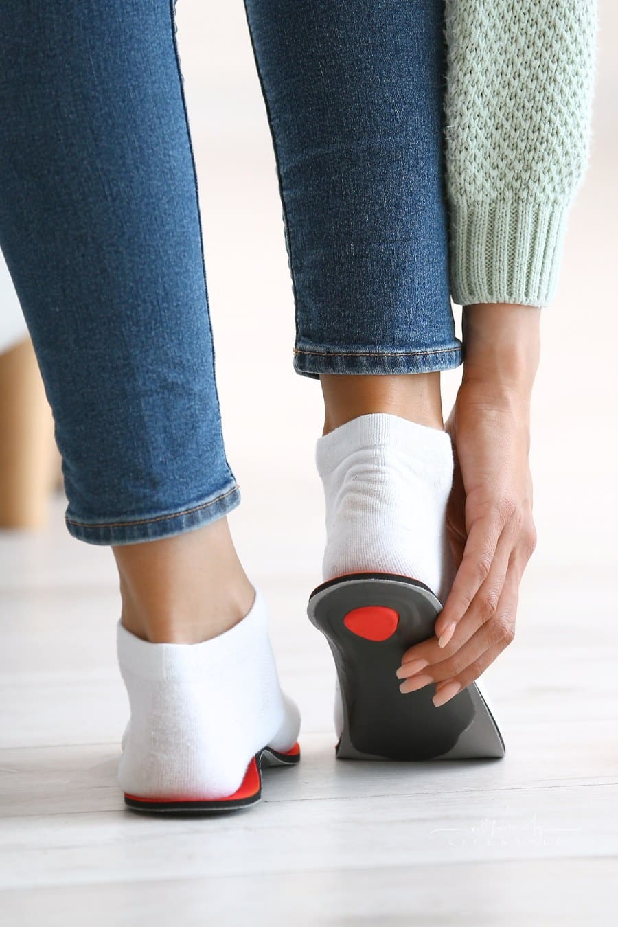 Woman Fitting Orthopedic Insoles at Home