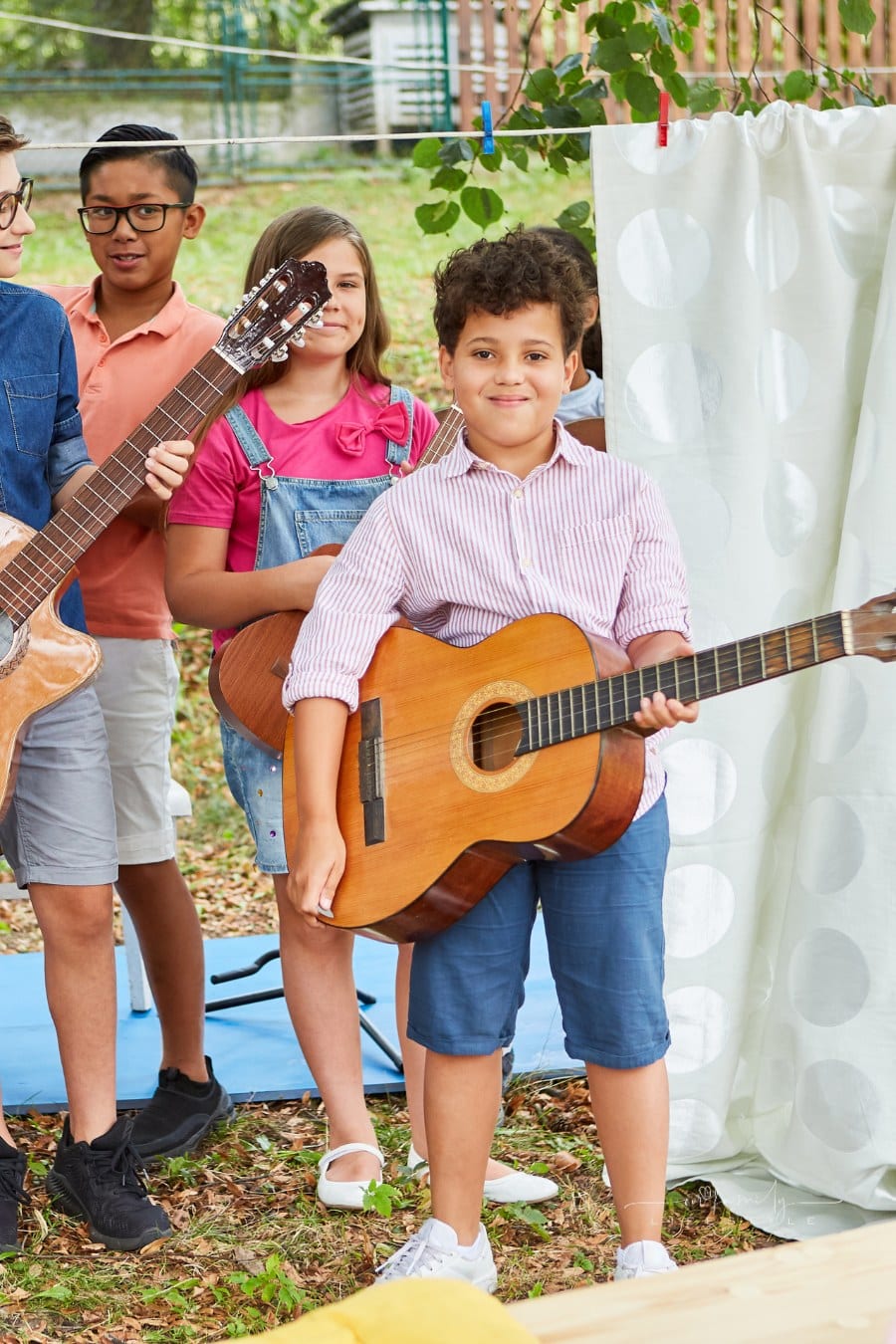 Group of Children at Family Talent Show in backyard