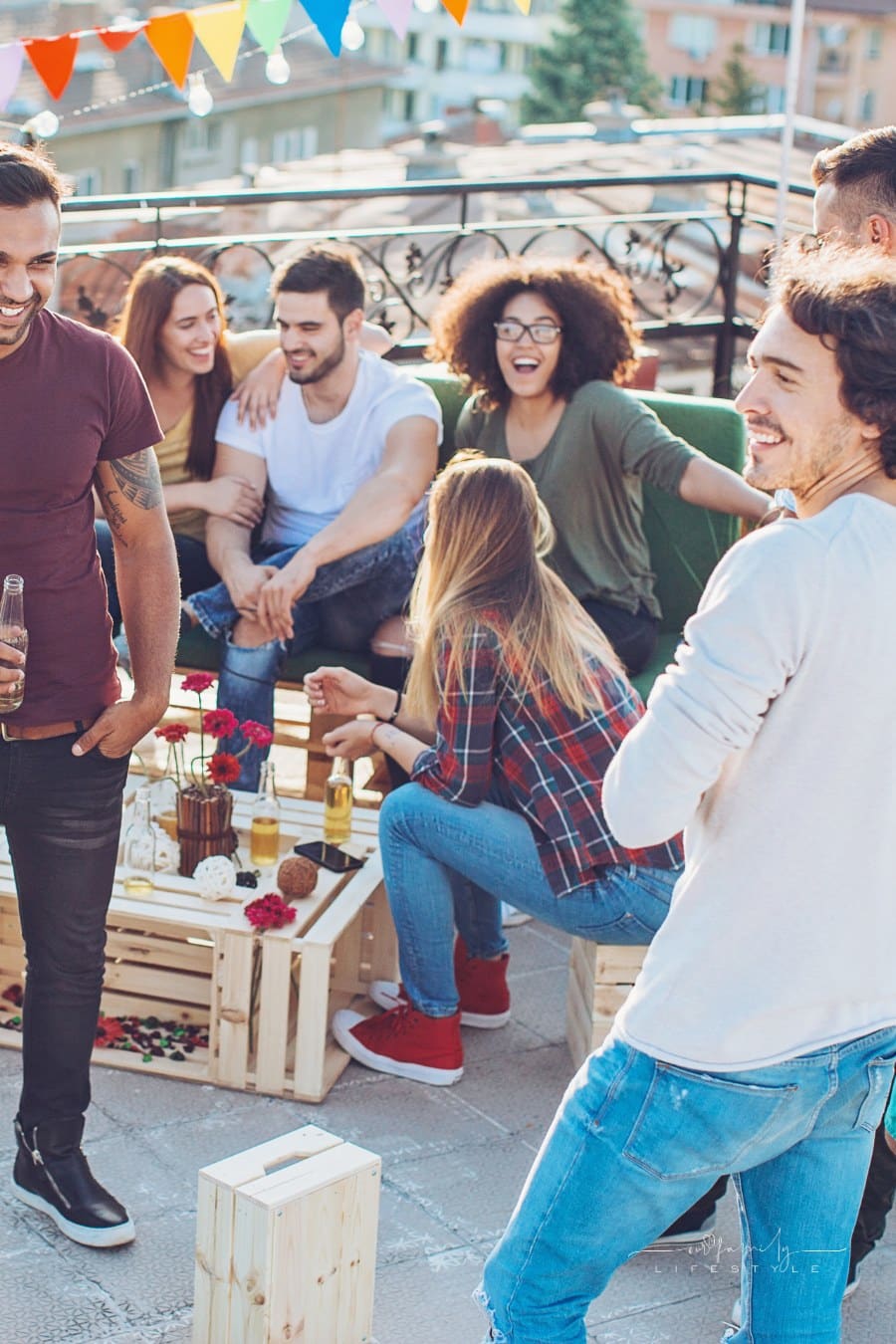 large party with young people and drinks on the rooftop with decorations and food
