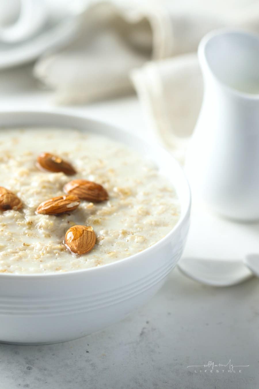 homemade oatmeal with almonds in a white bowl