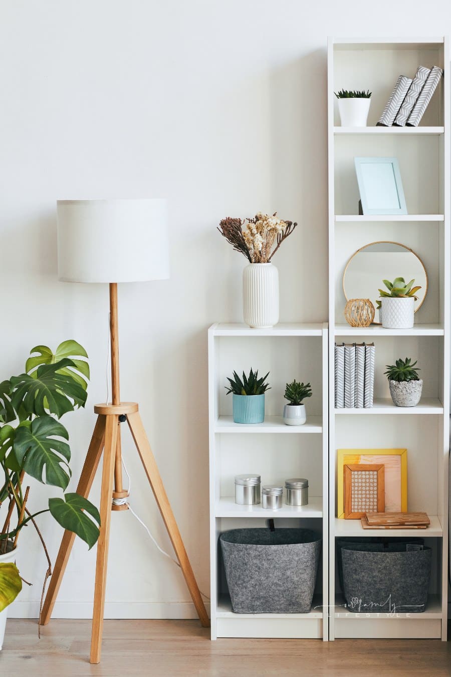 white vertical shelving next to a standing retro lamp