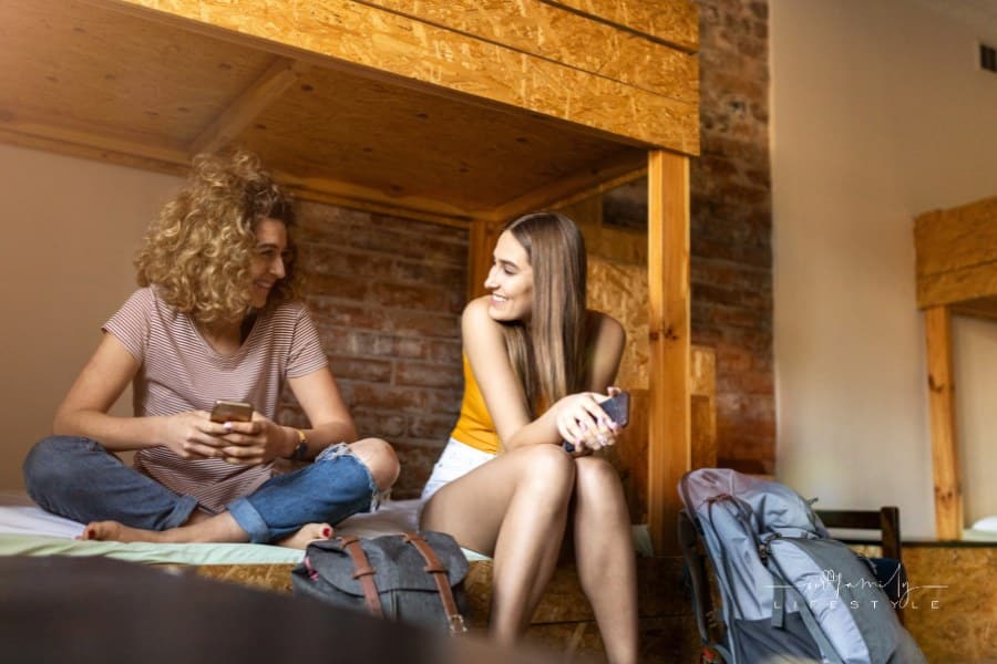two women talking while staying at a youth hostel