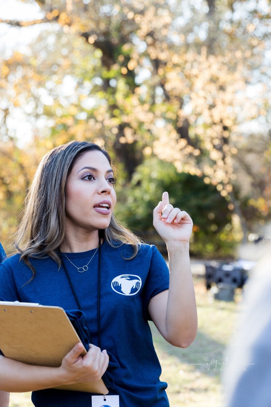Confident volunteer coordinator gives instructions during event