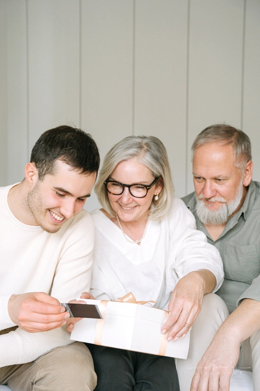 man showing elderly parents an instant camera picture