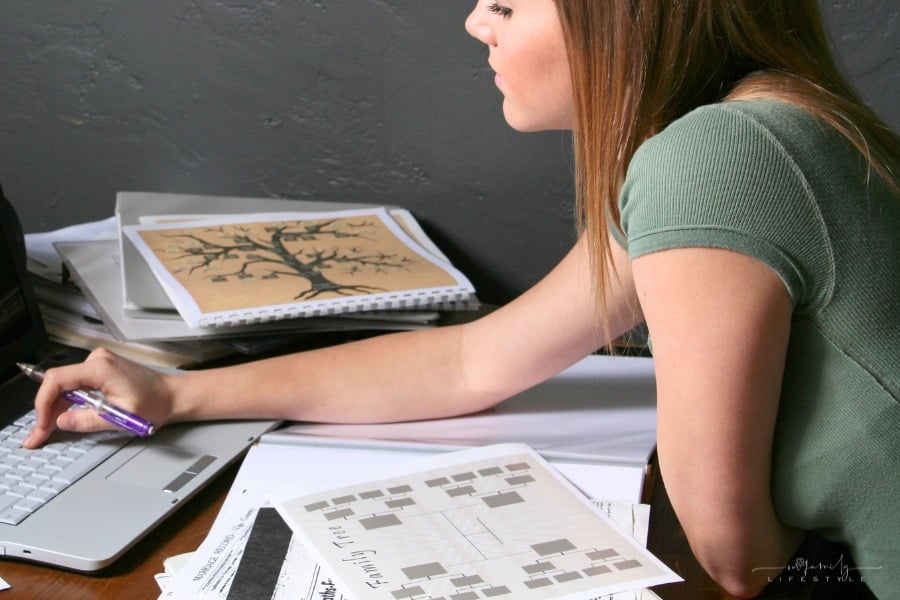 woman looking at genealogy and family tree on laptop