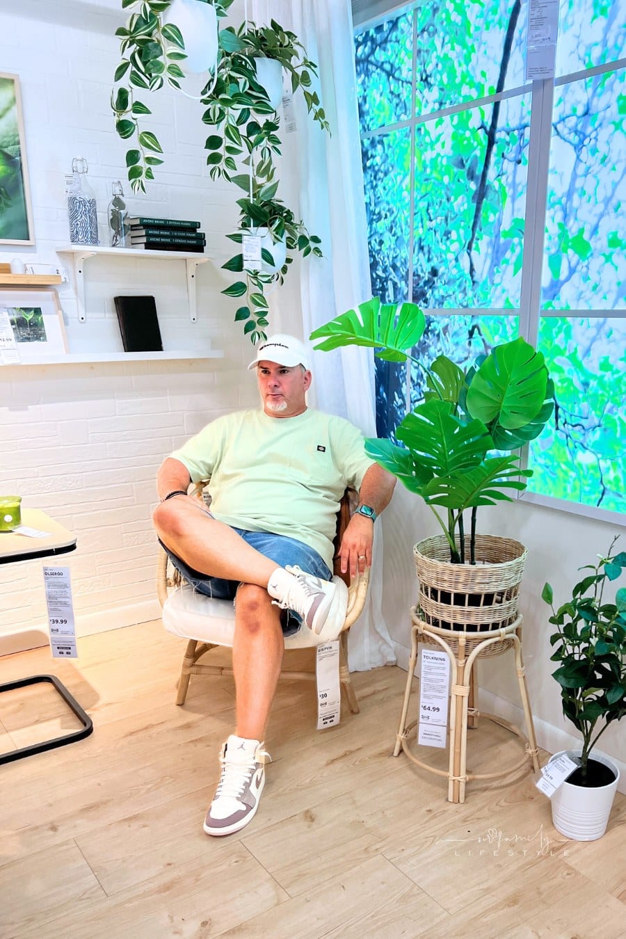 man sitting in a chair inside IKEA store vignette