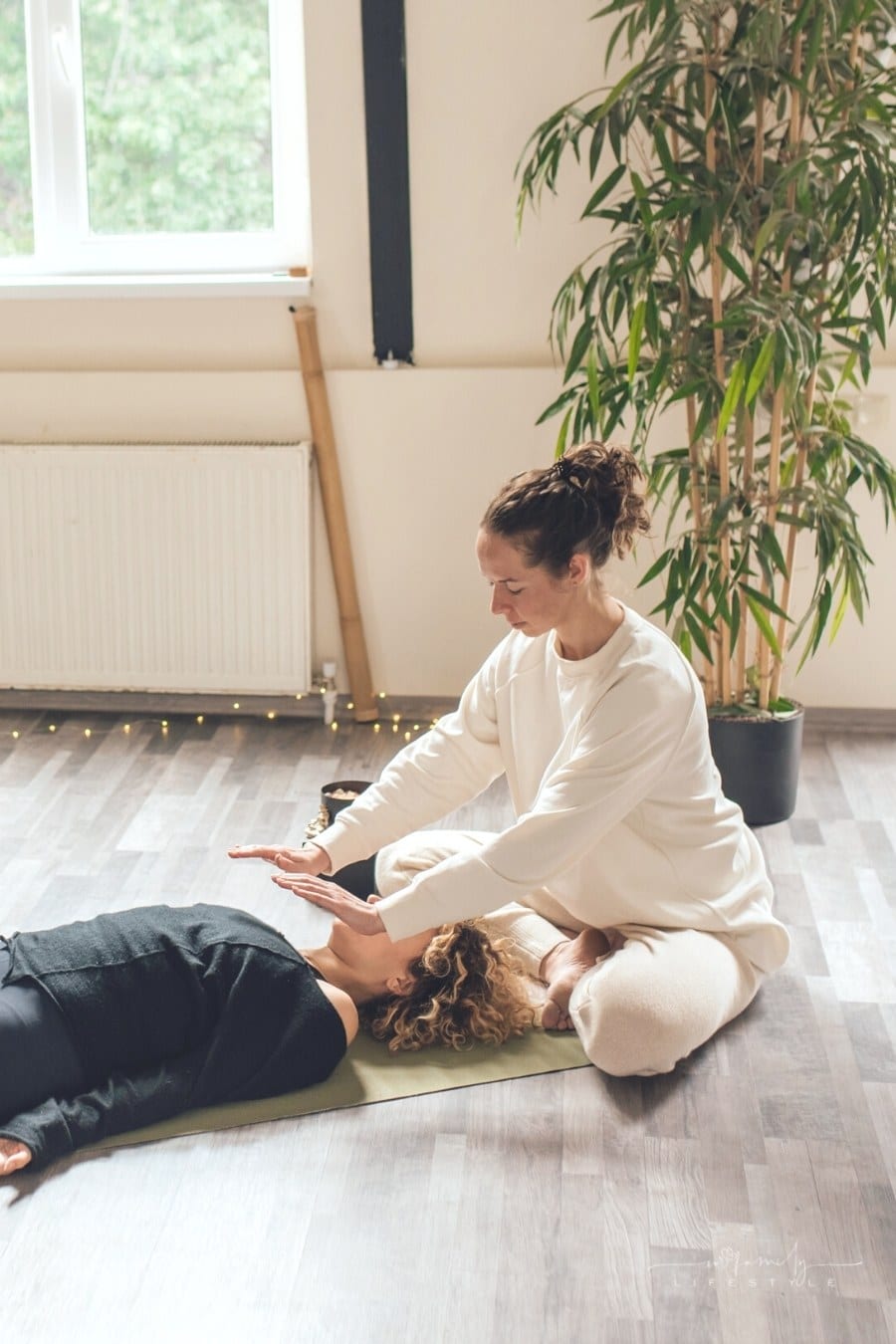spiritual energy healer with hands over patient