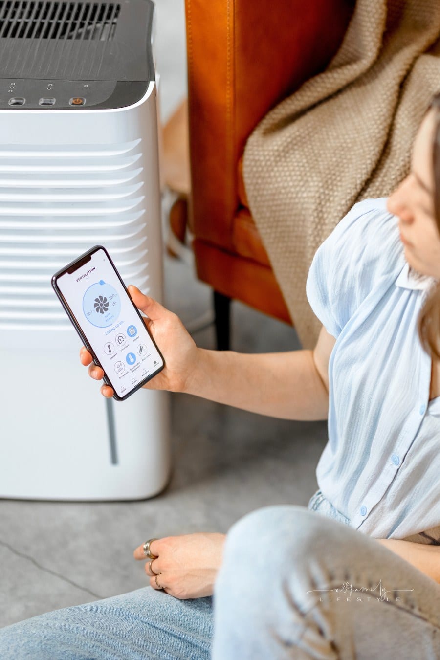Woman Sitting near Air Purifier and Moisturizer Appliance