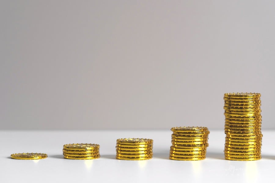 stacks of gold coins in upwards climb