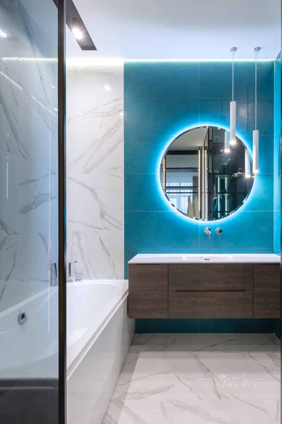 Contemporary interior of bathroom with bathtub and round mirror