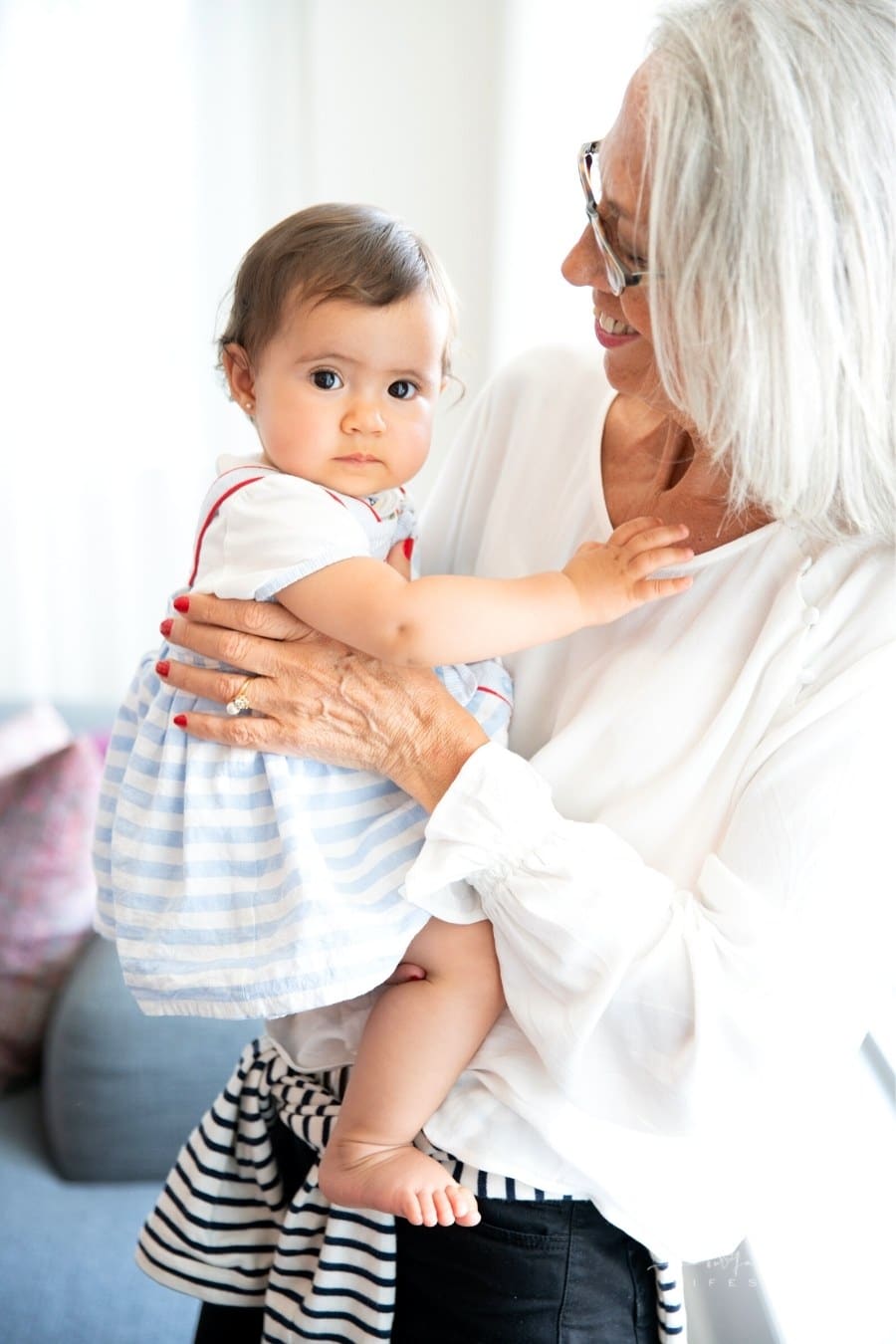 elderly woman holding a toddler girl