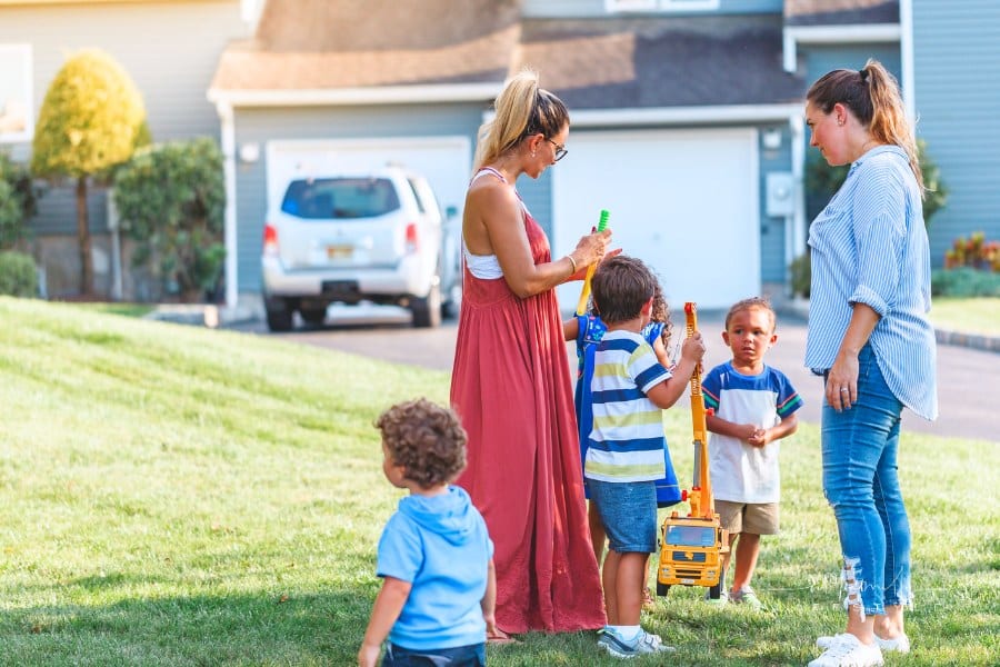 Neighbors talking and kids playing