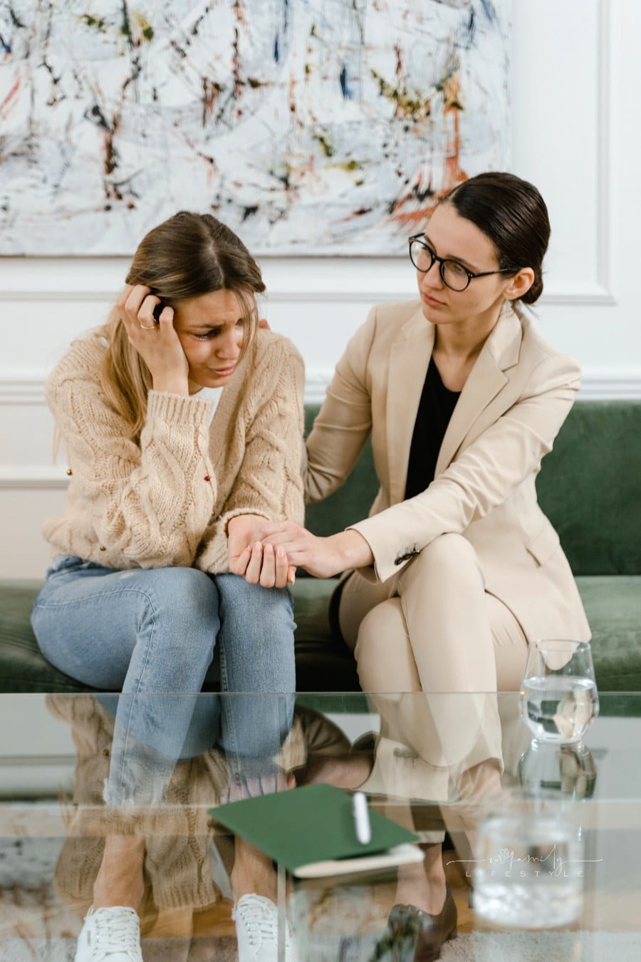 Woman Wearing Beige Blazer Comforting the Crying Woman