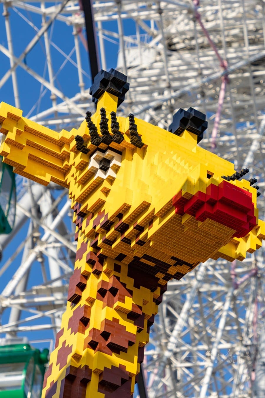 A picture of a giraffe made of Lego, on display next to the Tempozan Giant Ferris Wheel (Osaka).
