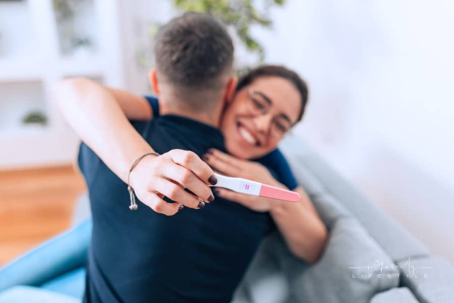 Happy Couple Holding a Positive pregnancy test