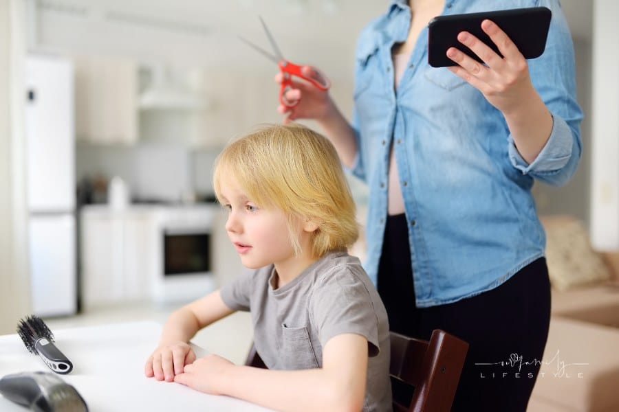 Mom Giving Young Son a Haircut at Home
