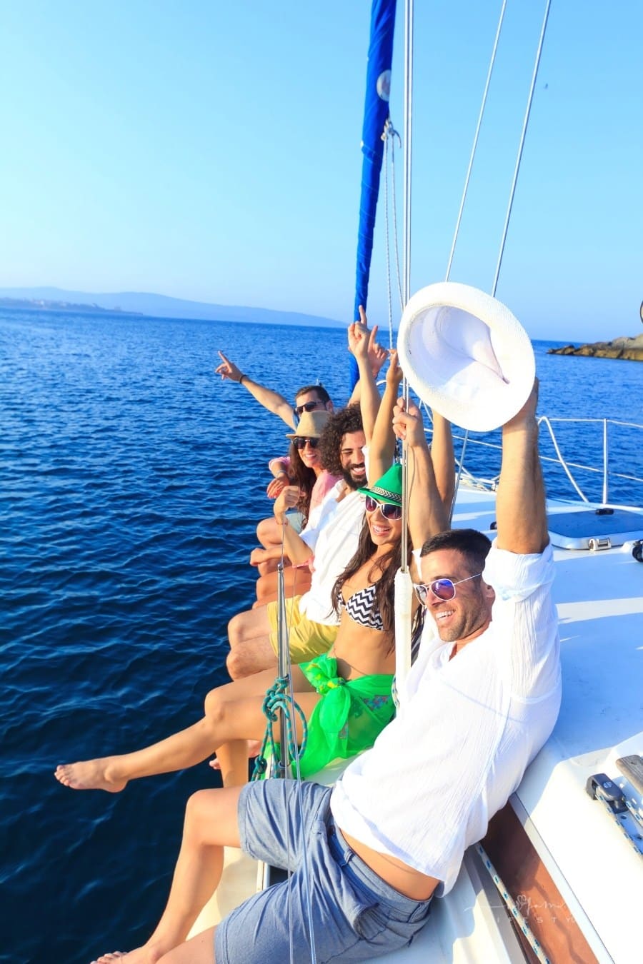 grip of friends traveling on a yacht at sea