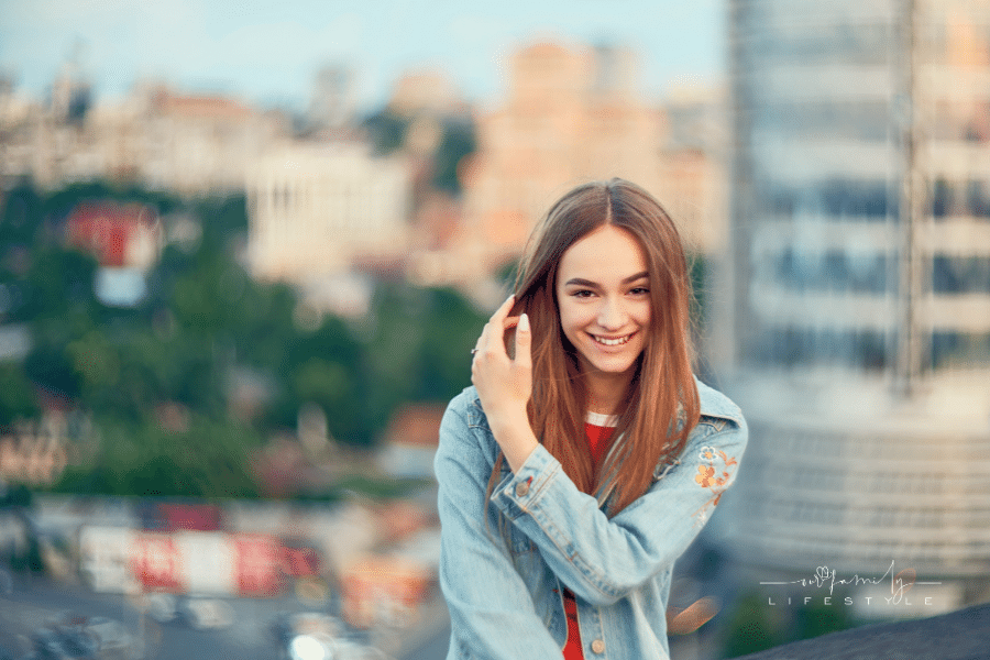 Lovely teen smiling on cityscape background