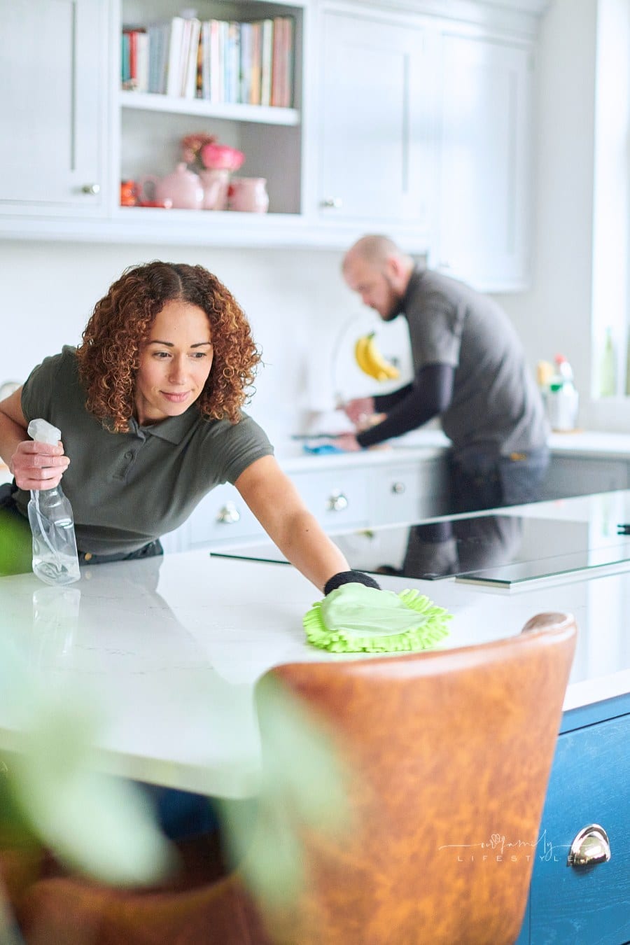 professional cleaning team in residential kitchen
