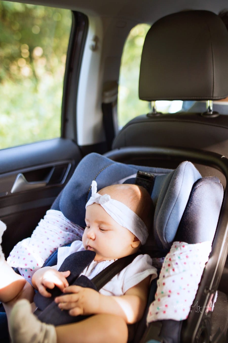 Unrecognizable Man Driving with a Baby Girl