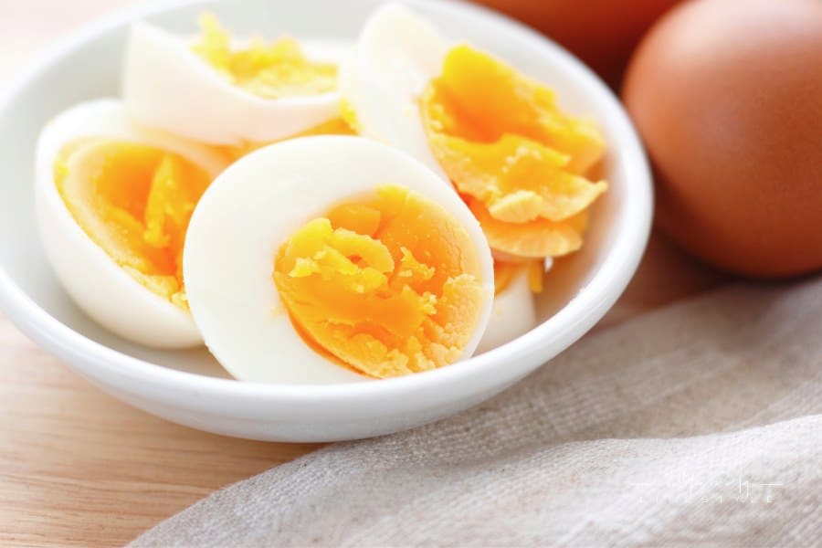 Sliced-hard boiled eggs in small white dish