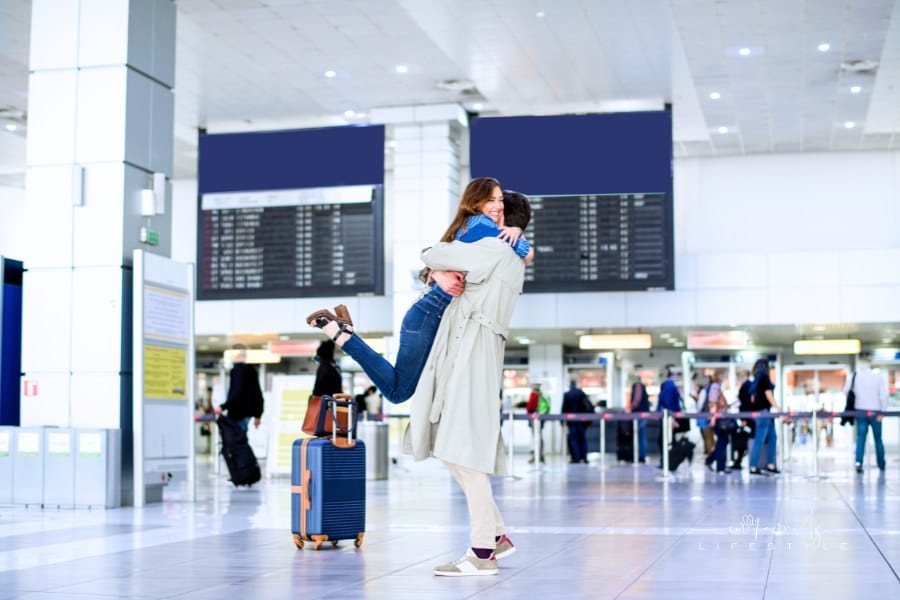 Hugging couple in international airport