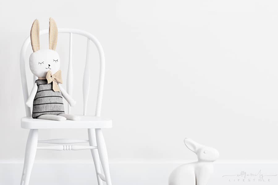 modern minimalist clean baby nursery with plush bunnies