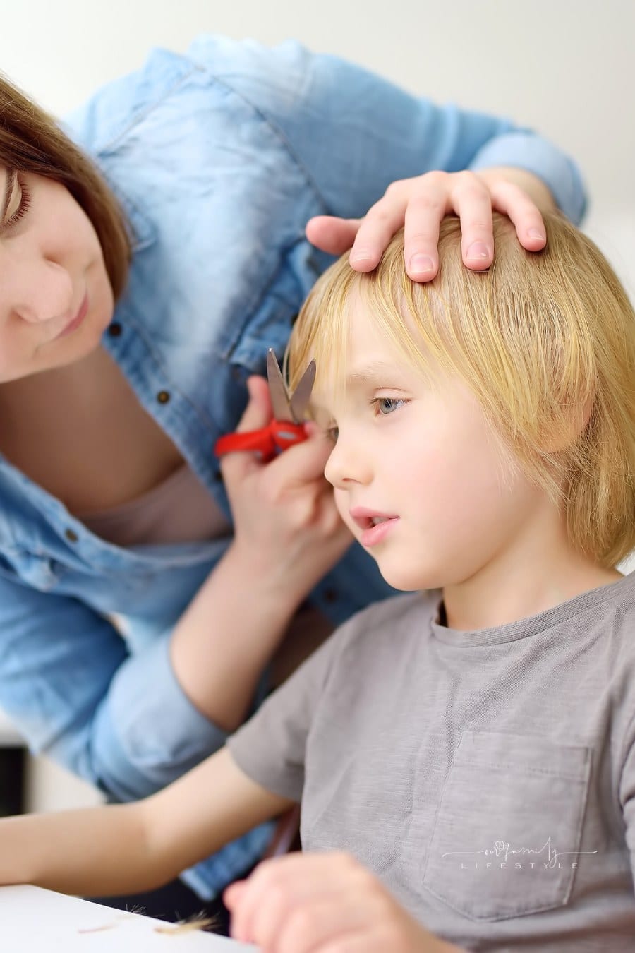 Mom Giving Young Son a Haircut at Home