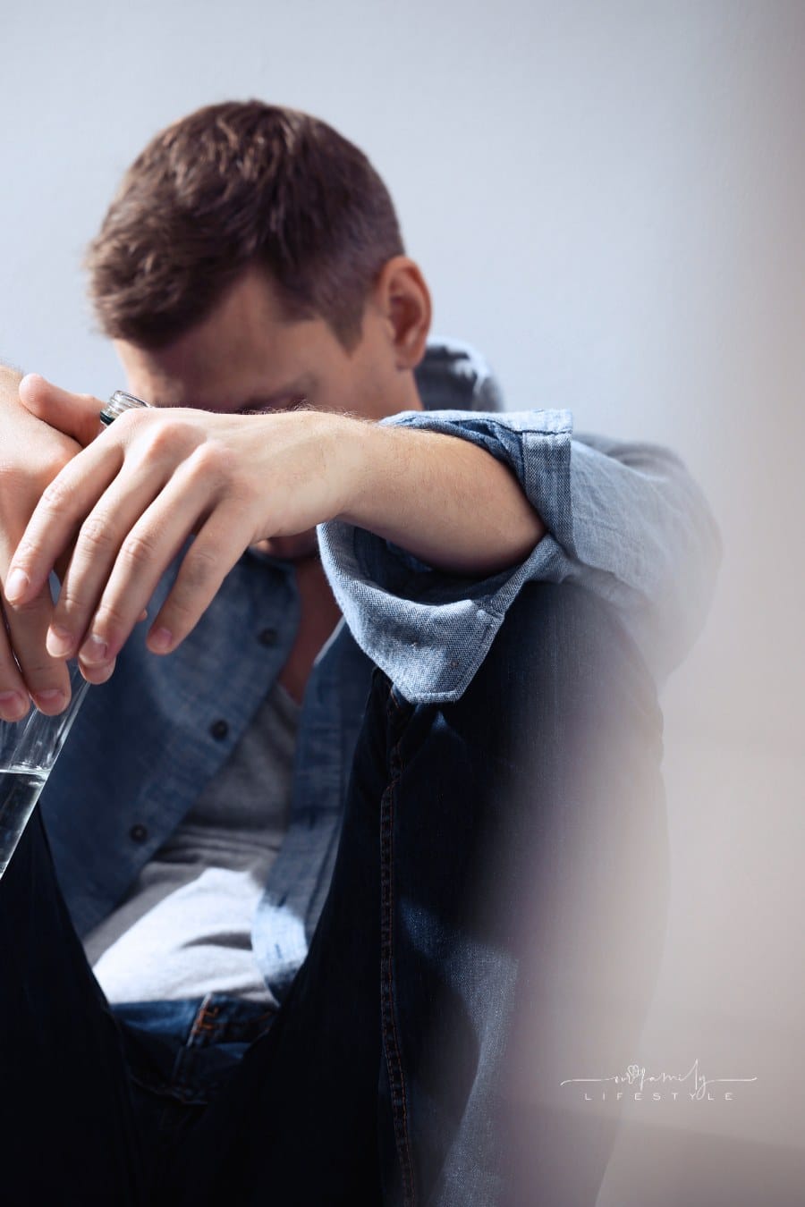Addicted Man with Alcoholic Drink near Beige Wall