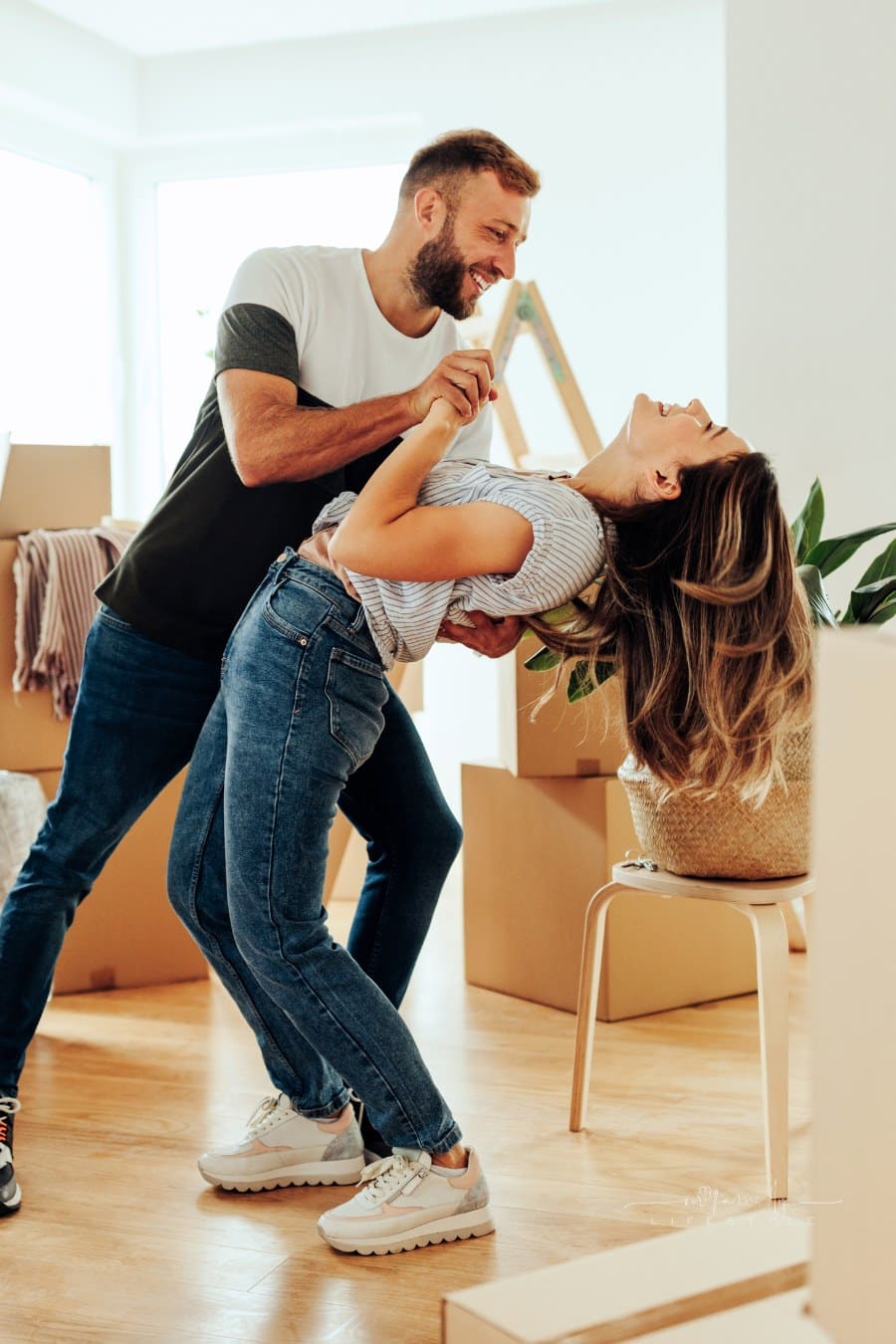 Couple dancing in new apartment.