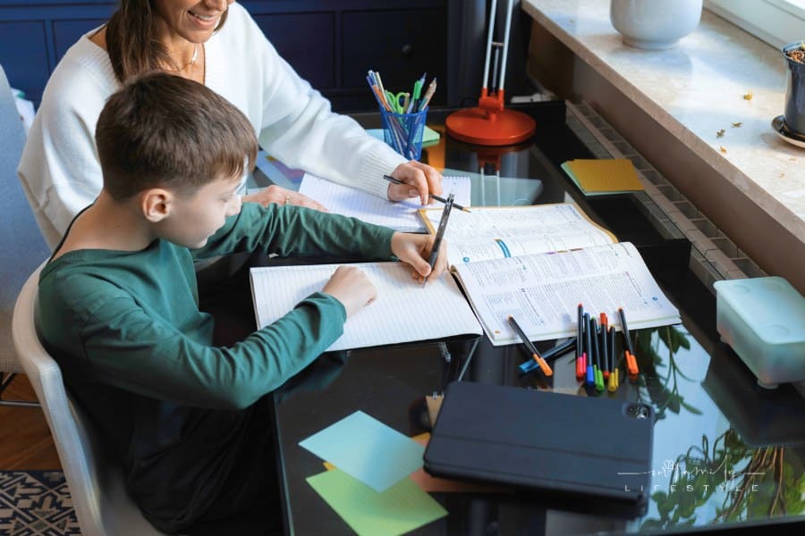 Mother helping her son with school work
