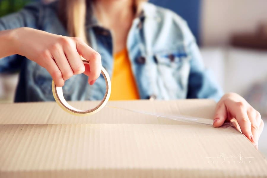 Girl Sealing Box with Tape Up Close