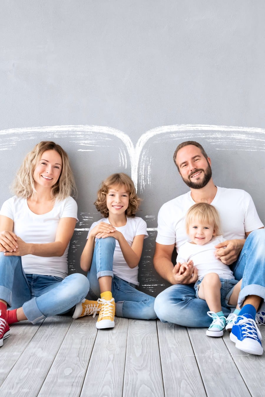 Family Sitting against a Wall with Chalk Drawings