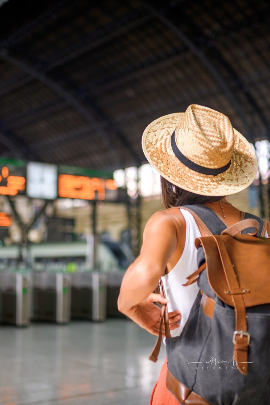 Female traveler at the train station waiting for her train.